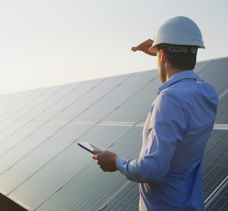 An young engineer is checking with tablet an operation of sun an